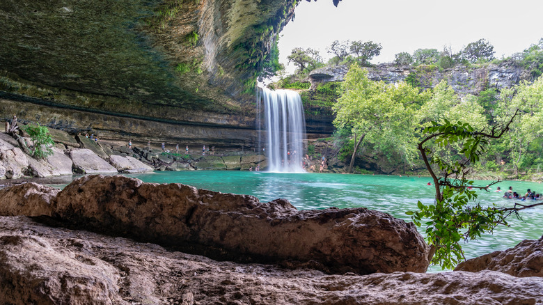 A wide shot of the waterfall at Hamilton Pool Preserve in Dripping Springs, Texas