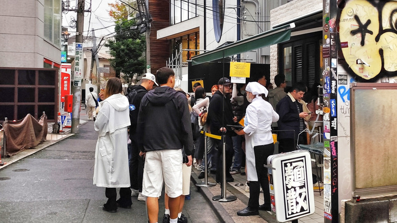 People in a line outside a restaurant in Japan