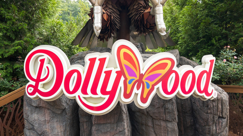 Dollywood logo signage amid a rustic woodland setting