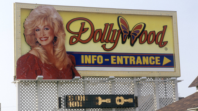 "Entrance" and "Info" sign for Dollywood featuring a large portrait of Dolly Parton