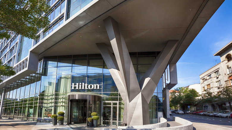 View of the entry sign on a modern, glass Hilton hotel in center of Belgrade, Serbia