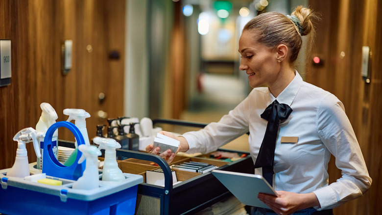 Hotel housekeeping supervisor checking supplies while working in a hotel