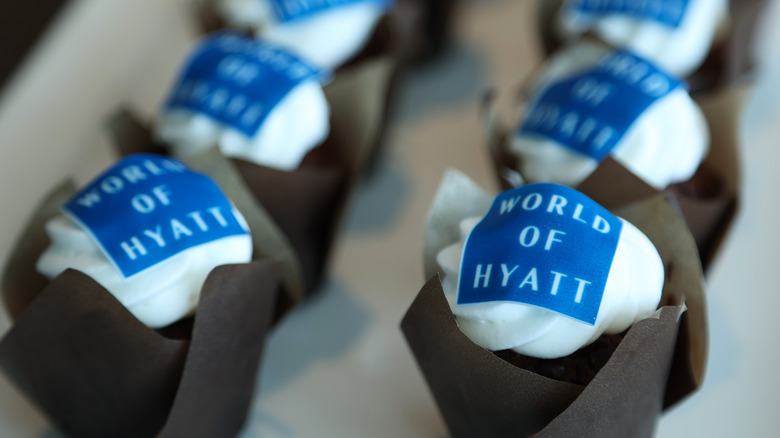Close-up view of World of Hyatt branded cupcakes at an event
