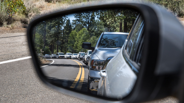 Side mirror view of long, backed up line of traffic near Emerald Bay in South Lake Tahoe, California