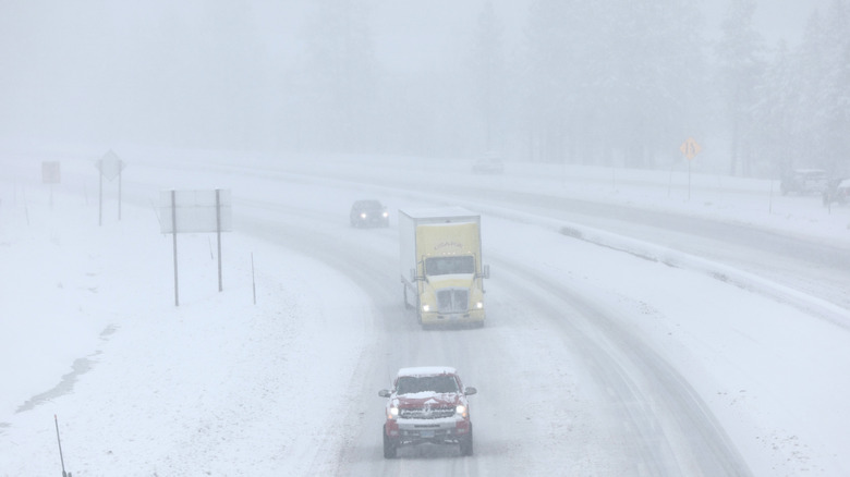 Vehicles drive on I-80 on treacherous snowy roads near Lake Tahoe during a winter storm