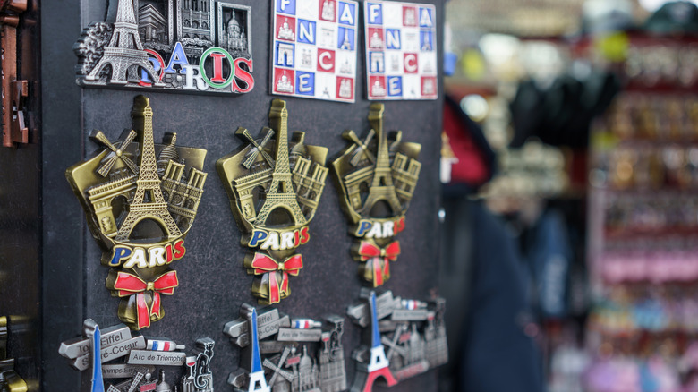 Miniature Eiffel Tower magnets and more souvenirs on display by a street vendor in Paris