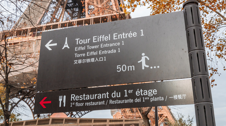 Eiffel Tower entrance 1 and first floor restaurant sign in Paris, France in October