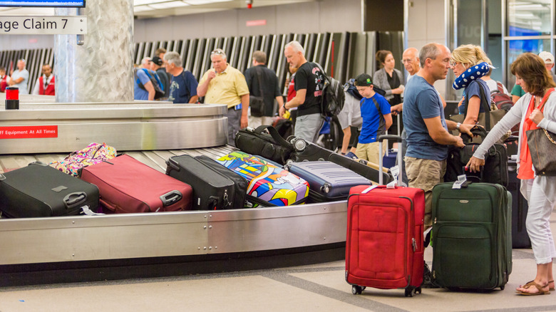 Travelers waiting for their luggage at the baggage carousel at Denver International Airport