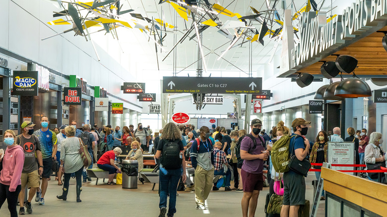 View inside the C Terminal at Denver International Airport, with many people waiting in fast food lines