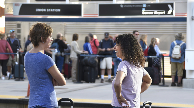 Passengers with luggage stand on the Union Station platform as they wait for the light rail commuter train which connects the railroad station with Denver International Airport