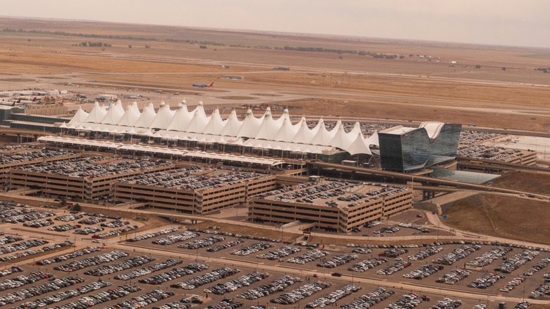 Aerial photograph of the remote main Jeppesen Terminal of the Denver Airport and surrounding parking structures