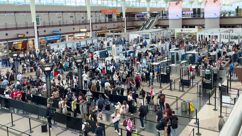 An overhead view of a crowded TSA security checkpoint at Denver International Airport