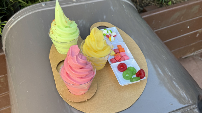 Platter of Dole Whips and candy sitting on an Epcot trash can table during the Epcot International Flower & Garden Festival