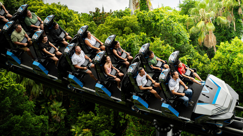 Close up of guests riding Velocicoaster through the trees at Universal Studios Orlando Resort
