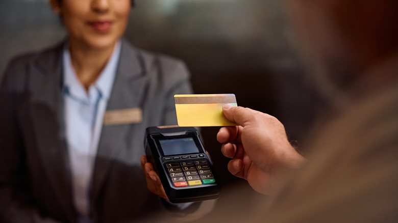 A guest paying the final bill at a hotel