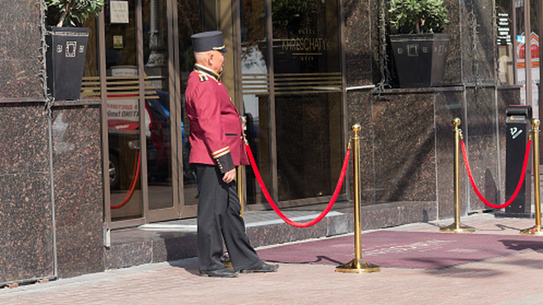 A doorman at the entrance of a hotel