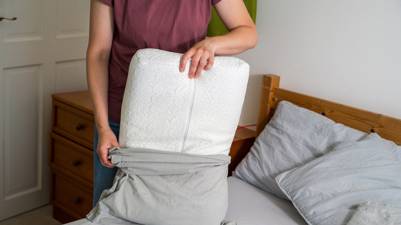 A person changing sheets