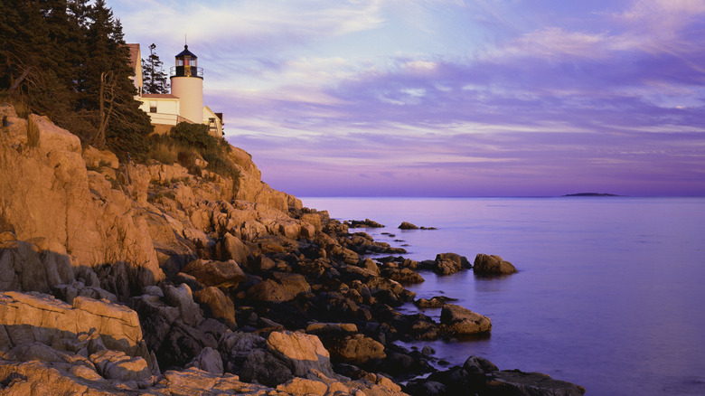 Sunrise with rocky cliffs at Bass Harbor Lighthouse in Acadia National Park, Maine