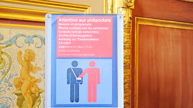 A 'beware pickpockets' sign in the Louvre Museum