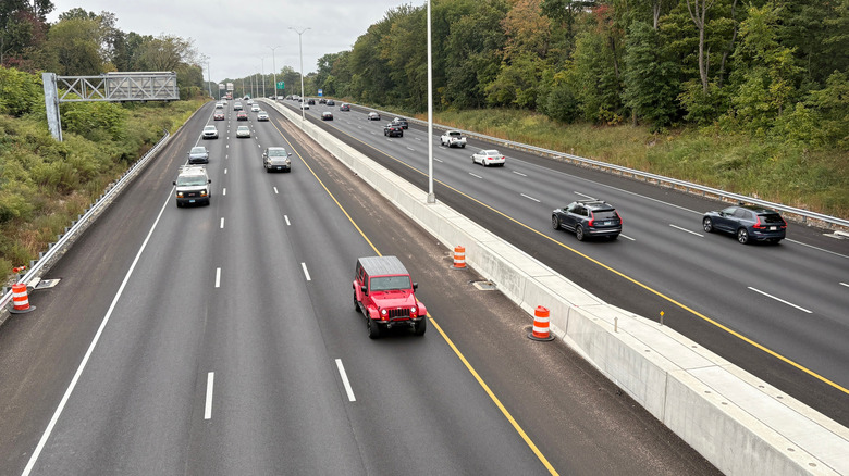 Red car driving in left lane in Connecticut