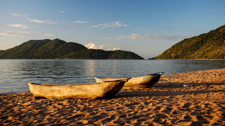 A pair of wooden canoes on the edge of the water of Lake Malawi, Malawi