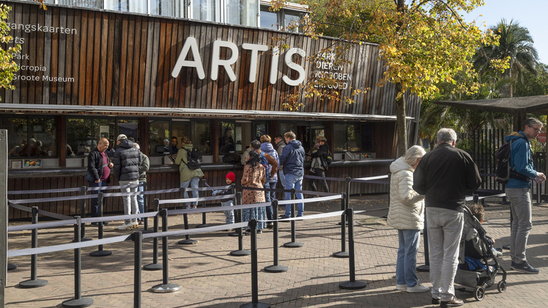 View of people watiing at the entrance and ticket sale line at the Artis Zoo in the center of Amsterdam.