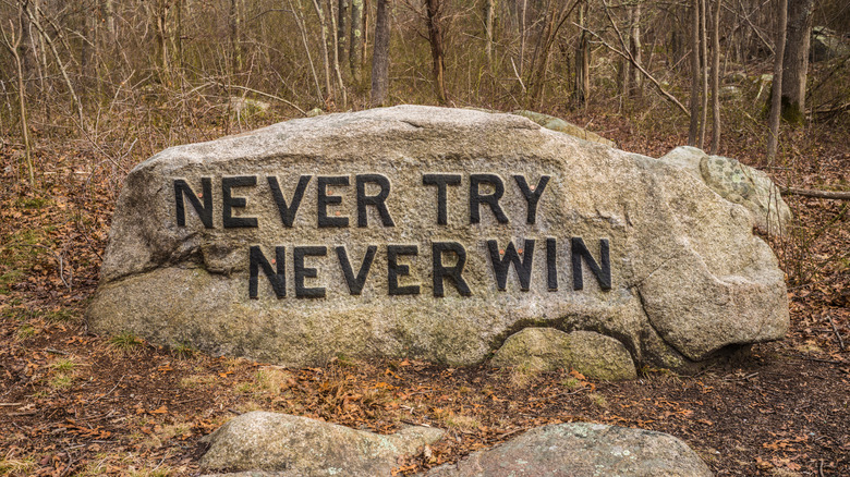 A boulder with a phrase carved into it in Dogtown, Massachusetts