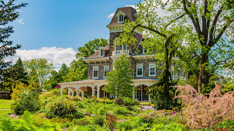 A historic mansion surrounded by green trees and lawns at Cylburn Arboretum.