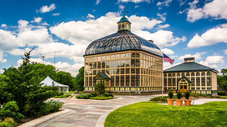 A plant-lined path leads to Rawlings Conservatory in Druid Hill Park, Baltimore.