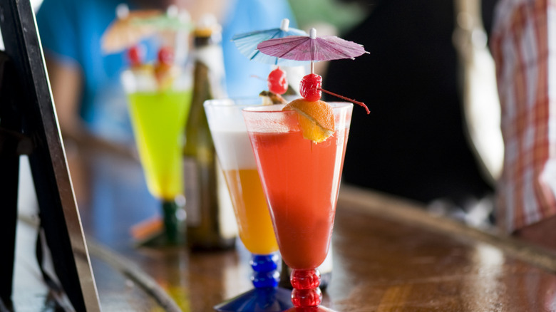 Colorful tropical cocktails displayed at the pool bar on a cruise ship