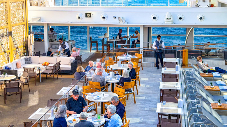 View from above of waiters serving passengers dining alfresco for dinner on the cruise ship Viking Saturn