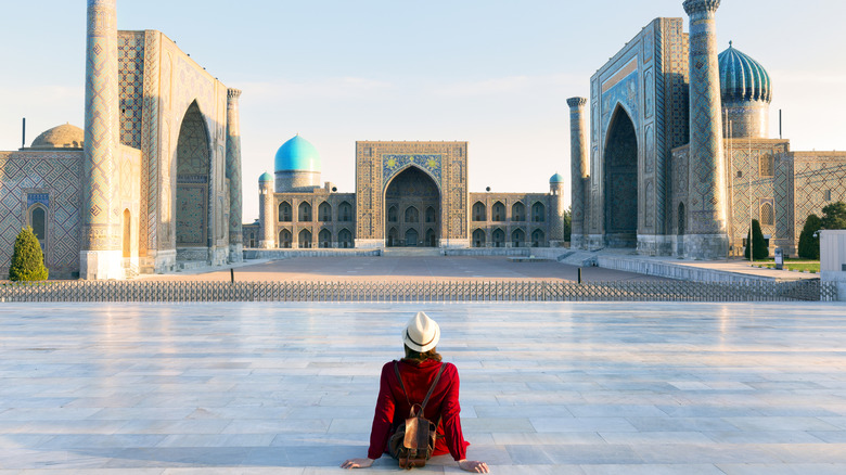 Person sitting in Registan Square in Uzbekistan