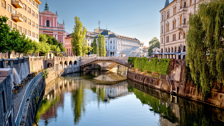 A scenic view of the Ljubljanica River as it winds through the historic center of Ljubljana.