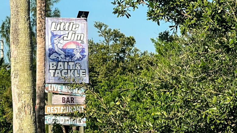 A sign for Little Jim Bait and Tackle surrounded by trees