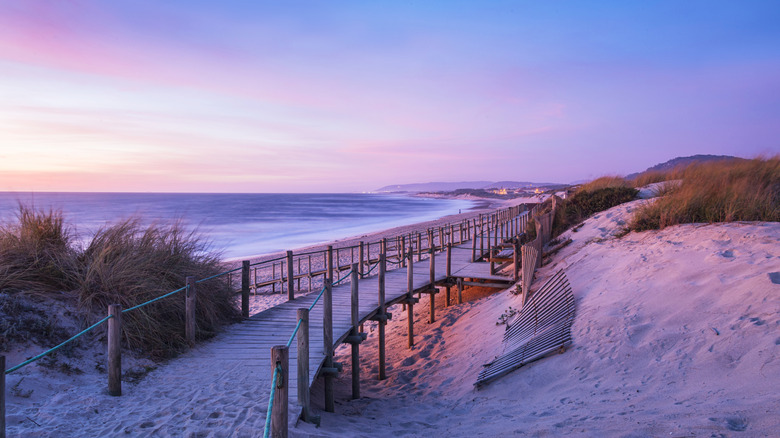A scenic sandy beach featuring a wooden walkway near Esposende