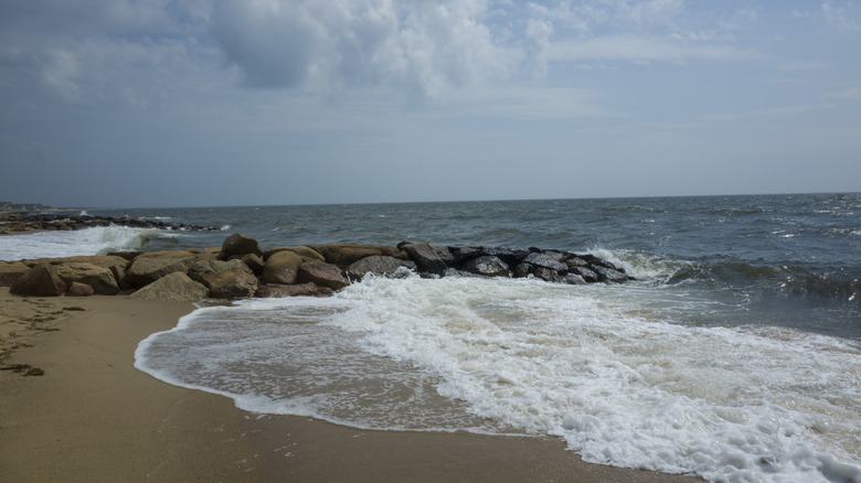 Dennis Port beach with waves breaking against jetties