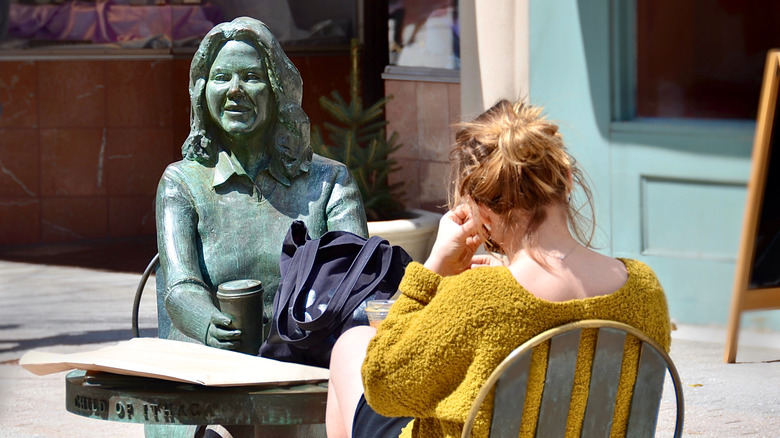 Person sitting across from sculpture in The Commons