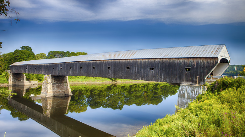 Cornish-Windsor Covered Bridge and lake on summer day.