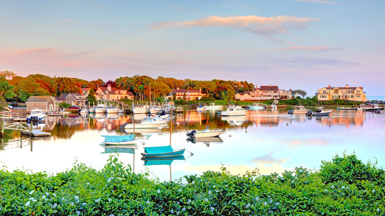 Harbor dotted with boats during sunset in autumn in Harwich, Massachusetts