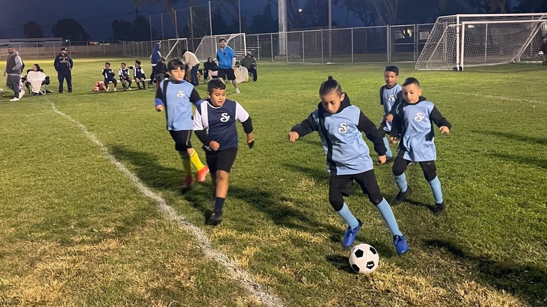 Children playing soccer at a park