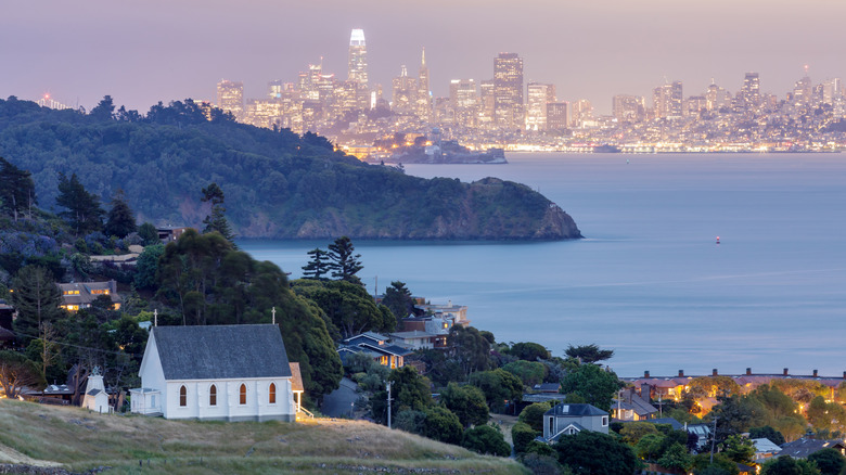 A white church on a hill overlooking Angel Island and the San Francisco skyline, in Tiburon, California