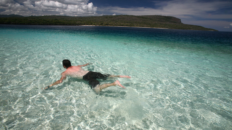 Man swimming in sea near Jaco Island, Timor-Leste