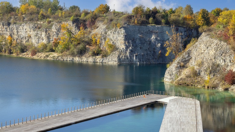 A pool surrounded by a deck floating on the Zakrzowek quarry
