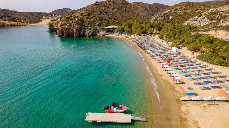 Aerial view of Vai Beach with its umbrellas, chairs, and watercraft