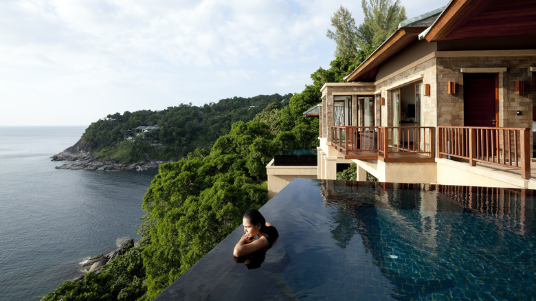 Person staring out at the view from an infiinity pool