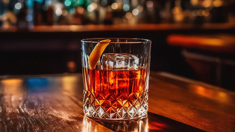 Old fashioned cocktail in a dark bar