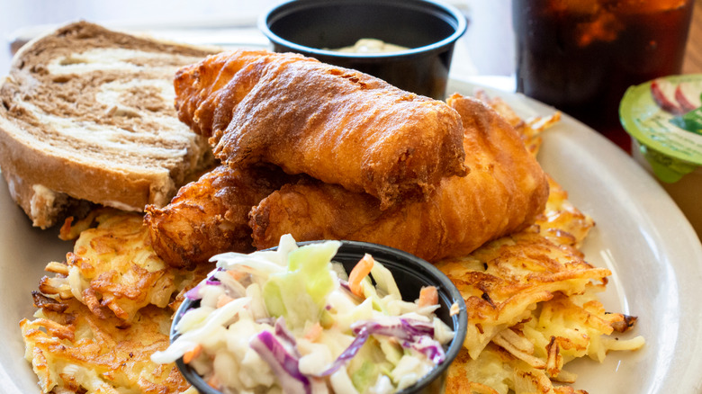 Quintessential Wisconsin fried fish with marbled rye bread, coleslaw, and potato pancakes.