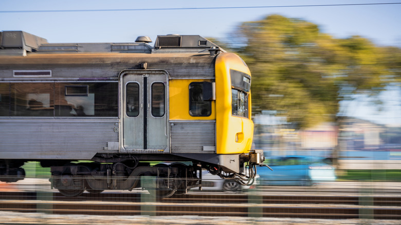 Passenger train traveling on a track at high speed
