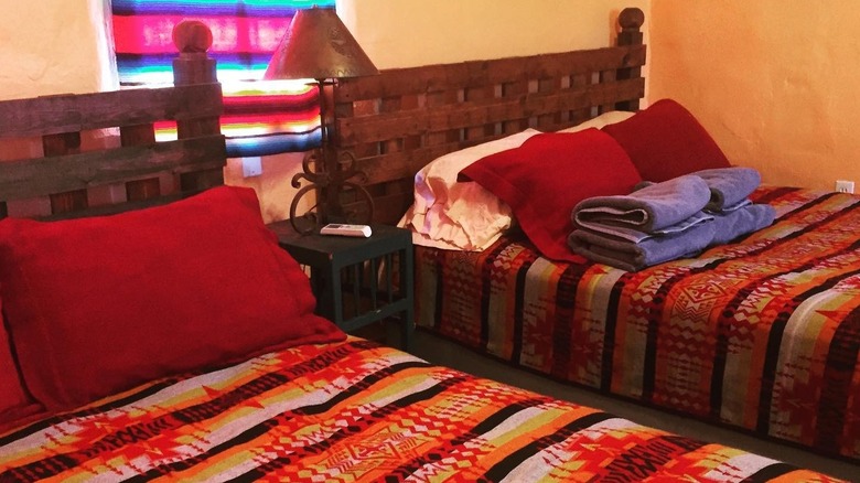 View of a colorfully decorated cabin bedroom at Chinati Hot Springs