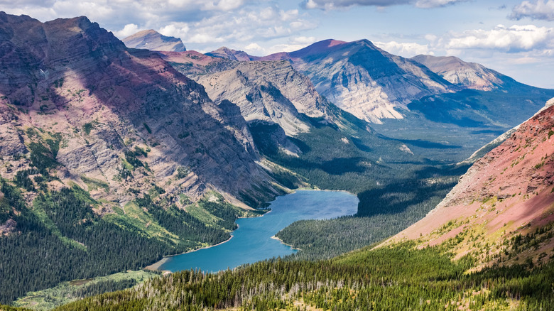 The Belly River Valley and Elizabeth Lake stretch into the distance below the Rocky Mountains in Glacier National Park